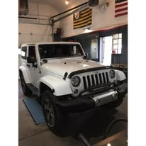 White Jeep Wrangler in service bay